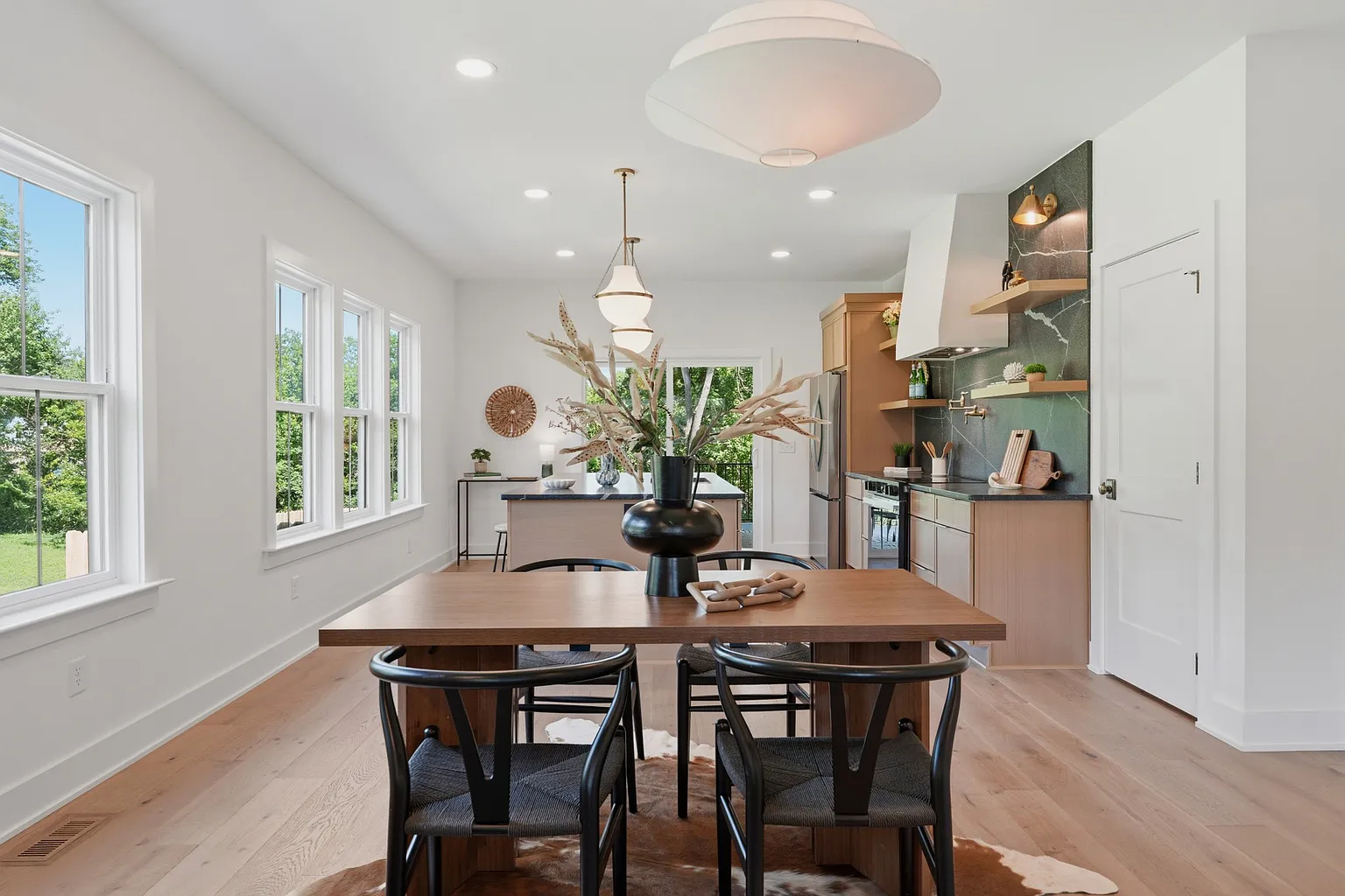 Dining room with brass pendants and oak table