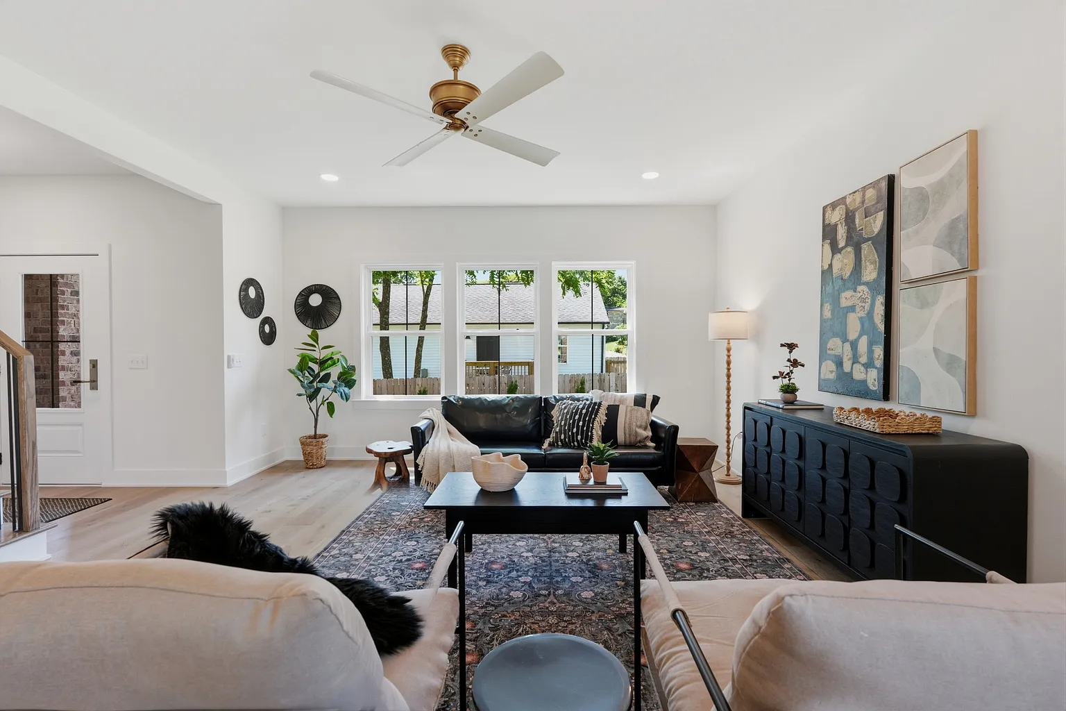 Living room with brick fireplace and linen sectional